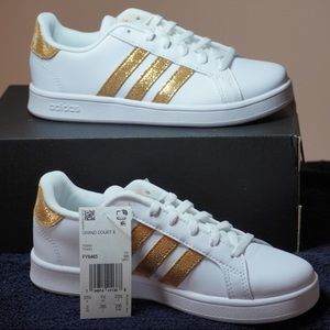 Adidas Grand Court K sneakers for little girls, white w/gold stripes.